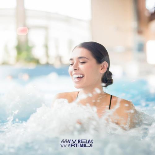 a young woman in a swimming pool at ARTEMIDE "Fiore Club" B&B SUITE SPA in Giffoni Valle Piana