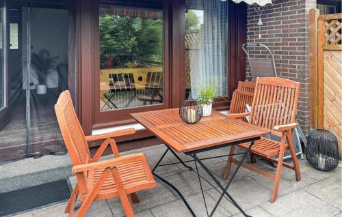 a wooden table and chairs on a patio at Amazing Home In Meschede With Wifi in Meschede