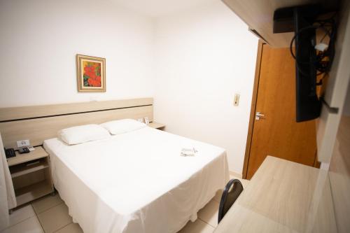 Ένα ή περισσότερα κρεβάτια σε δωμάτιο στο Ellus Hotel