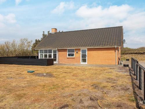 a house with a large yard in front of it at 8 person holiday home in Vestervig-By Traum in Vestervig