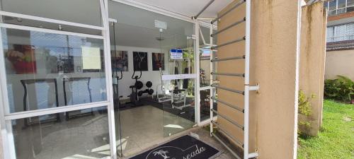 a room with sliding glass doors on the side of a building at Hotel Casa Enseada Guarujá in Guarujá