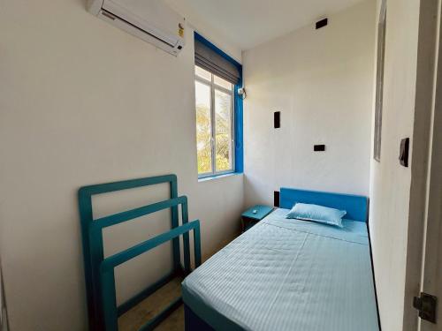 a small bedroom with a bed and a window at 234 Weligama in Pareiduwa