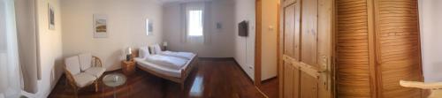 a bathroom with a sink and a bed in a room at Mooi Panzió in Nagyatád