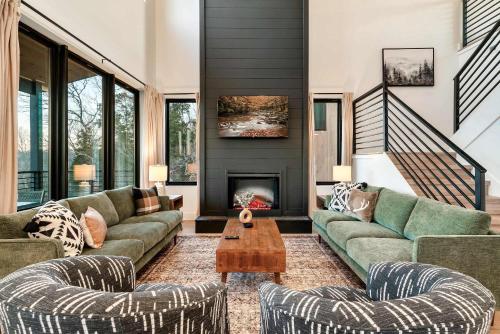 a living room with two couches and a fireplace at Modern Luxury Pool Hot Tub & Near Water Parks in Sevierville