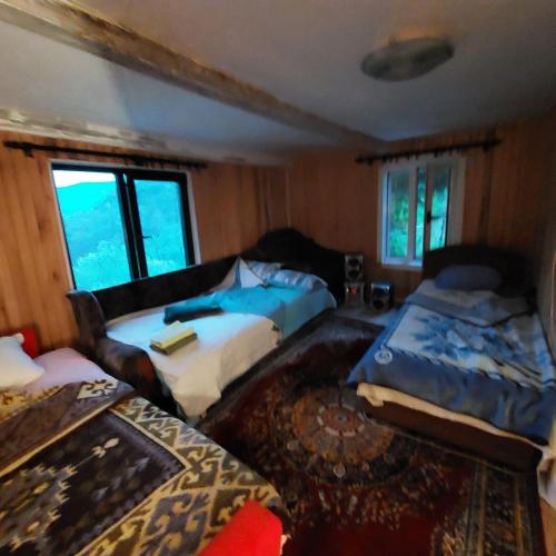a living room with two beds and a couch at Valley Tara in Pluzine