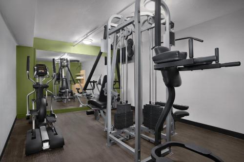 a gym with several tread machines in a room at Spark by Hilton Denver East I 70 in Denver