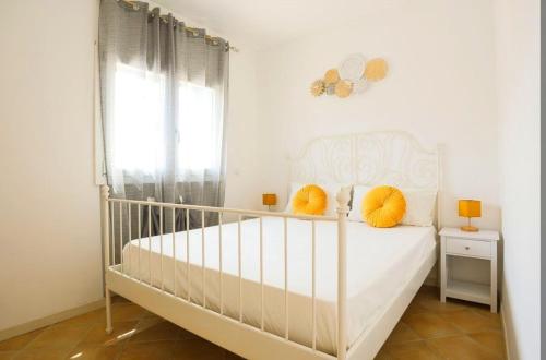 a white crib in a white bedroom with a window at Apartment 107 - Roma Fiumicino in Fiumicino