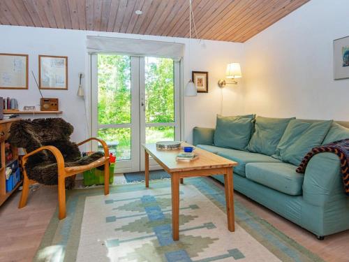 a living room with a blue couch and a table at 4 person holiday home in Bryrup-By Traum in Bryrup