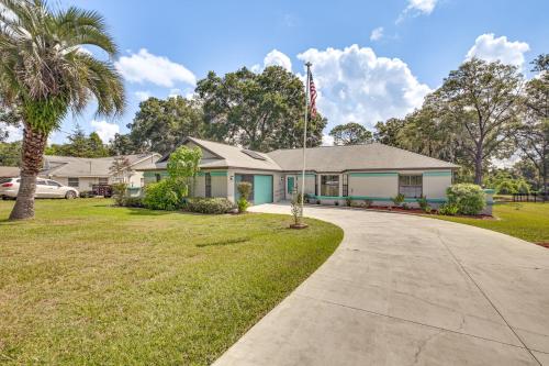 a house with a palm tree and a driveway at Golf Course Views! Home 10 Mi to Crystal River in Citrus Springs