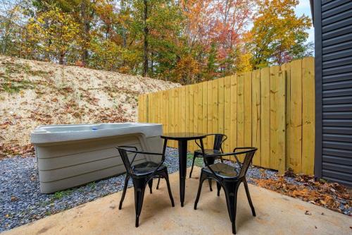 two chairs and a table next to a bath tub at Peaceful Escape 2BR Retreat w Private Hot Tub in Sevierville