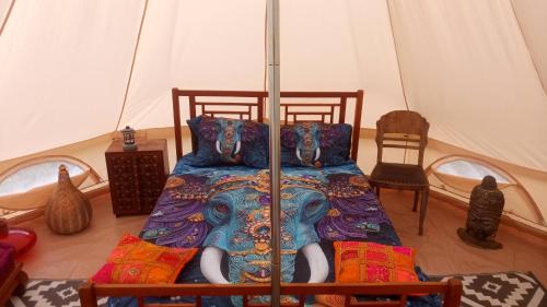 a bedroom with a bed in a tent at tente india in Le Pener