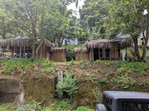 a house with thatched roofs on a hill at Ashokavanam Heritage Village by N Square in Kanthalloor