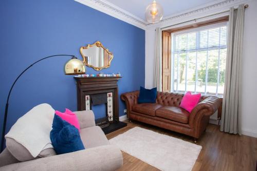 a living room with a couch and a fire place at 1 Bed Cosy Loch Lomond base in Bonhill