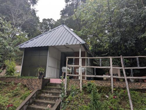 a small house with stairs leading up to it at Ashokavanam Heritage Village by N Square in Kanthalloor