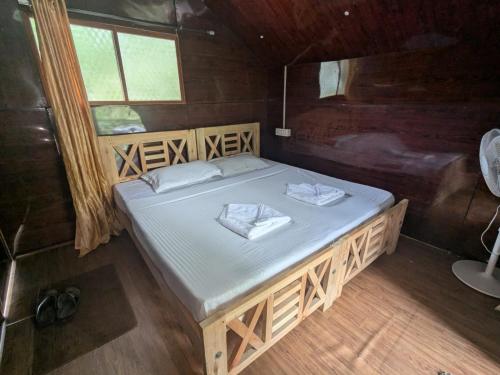 a bedroom with a large bed in a wooden room at Ashokavanam Heritage Village by N Square in Kanthalloor