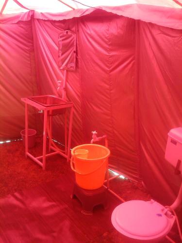 a pink tent with a toilet and a table at Himalayan Routes Camp Sarchu in Sir Bhum Chun