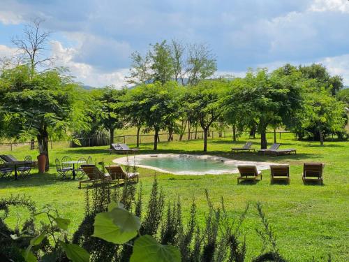 a park with benches and a pond in the grass at Antico Borgo di Sutri in Sutri