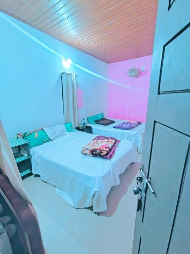 a room with two beds in a room with pink lights at Green porticos villa munnar #MUNNAR in Anachal