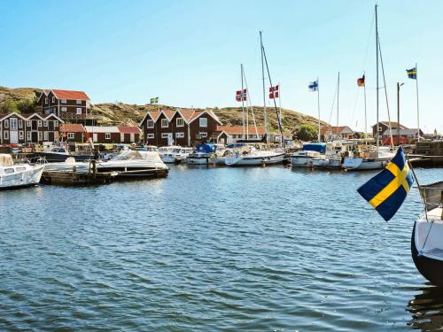 a group of boats docked in a marina with houses at 5 person holiday home in DYRÖN in Stora Dyrön