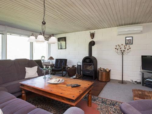 a living room with a couch and a wood stove at 6 person holiday home in Farsø in Farsø