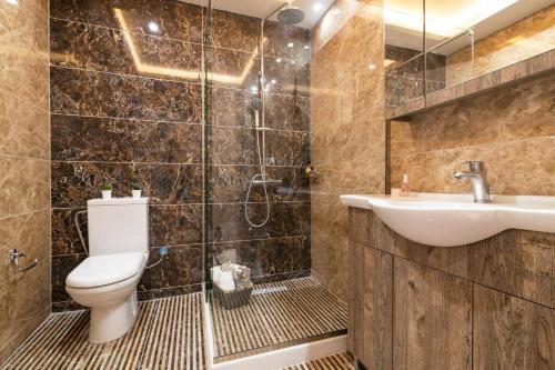 a bathroom with a toilet and a sink at Villa Amelina by Villa Plus in Lithakia