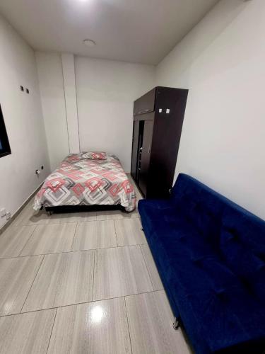a bedroom with a bed and a blue sheet on the floor at Apto, kennedy central amoblado in Bogotá