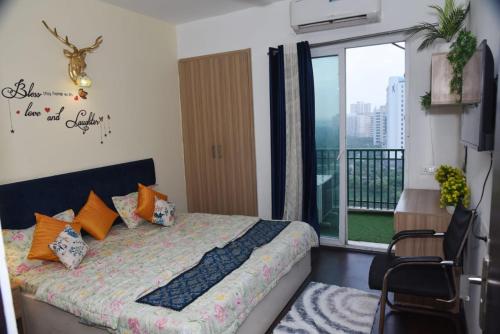 a bedroom with a bed and a balcony at Zoom Stay Sector 168 Noida 1bhk in Noida