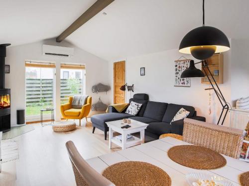 a living room with a couch and a table at 6 person holiday home in Væggerløse in Marielyst
