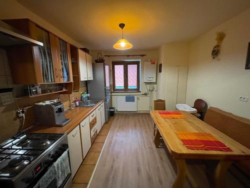 a kitchen with a wooden table and a counter top at Lovely entire apartment in Cugir in Cugir