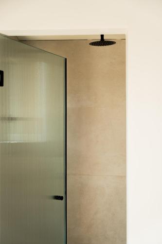 a glass door in a hallway with a ceiling at Astoria Hotel in Agia Galini