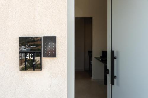 a door with a clock on the side of a wall at Astoria Hotel in Agia Galini