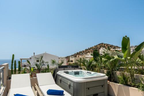 a hot tub on the balcony of a house at Astoria Hotel in Agia Galini