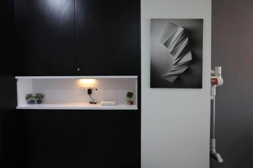 a bathroom with black cabinets and a white sink at SS15 Courtyard Subang Jaya Sunway Home Cinema Projector Studio 120 Inches in Subang Jaya