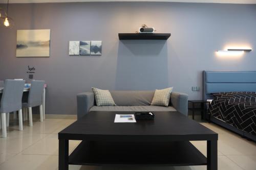 a living room with a couch and a table at SS15 Courtyard Subang Jaya Sunway Home Cinema Projector Studio 120 Inches in Subang Jaya