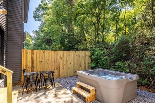 a backyard with a hot tub and a table and chairs at Serene Retreat Private Hot Tub and Arcade in Sevierville