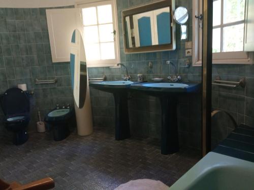 a bathroom with two sinks and a toilet and a mirror at Domaine Tombarel - Agritourisme in Brignoles