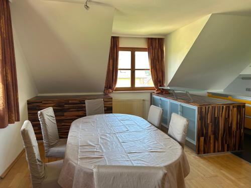 a room with a table and chairs and a window at Haus Knafl in Kappel am Krappfeld