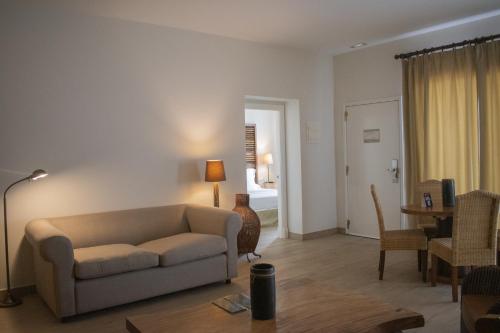 a living room with a couch and a table at Fairplay Golf & Spa Resort in Benalup Casas Viejas