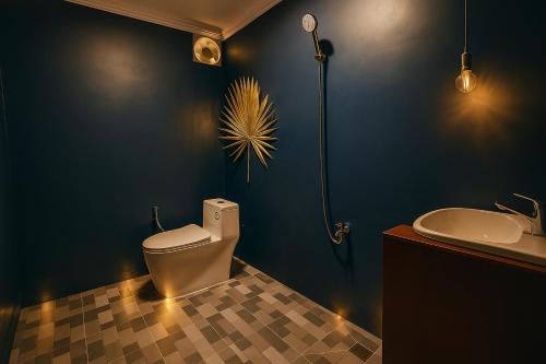 a bathroom with a toilet and a sink at The Naturus Eco Home Battambang in Phumĭ Ândong Pring