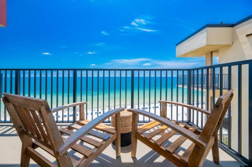 two chairs on a balcony with a view of the ocean at Phoenix II 2151 condo in Romar Beach