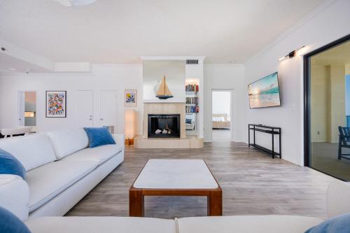 a living room with a white couch and a fireplace at Phoenix II 2151 condo in Romar Beach