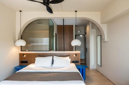 a bedroom with a bed with two blue tables at Astoria Hotel in Agia Galini