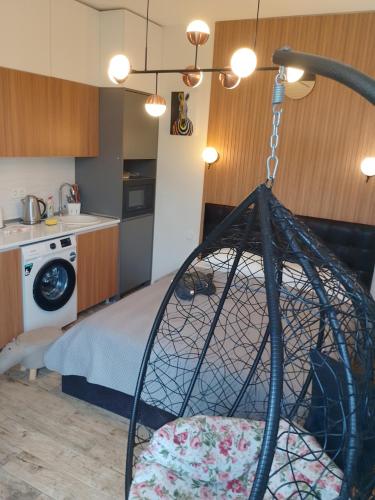 a room with a bed and a kitchen at Стильная квартирка у моря in Batumi