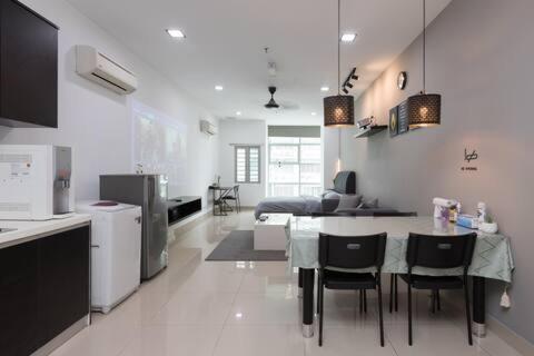 a kitchen and living room with a table and chairs at SS15 Courtyard Subang Jaya Sunway Home Cinema Projector Studio 120 Inches in Subang Jaya