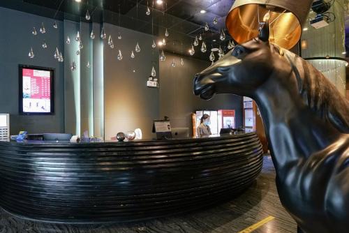 a statue of a horse in front of a bar at Paco Hotel Tiyuxilu Metro Guangzhou-Free Shuttle Bus during Canton Fair&5 Min walk to Canton Fair Buyer Registration Store in Guangzhou
