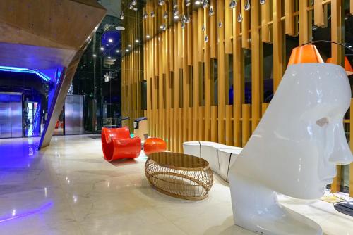 a room with a slide and a basket on the floor at Paco Hotel Tiyuxilu Metro Guangzhou-Free Shuttle Bus during Canton Fair&5 Min walk to Canton Fair Buyer Registration Store in Guangzhou