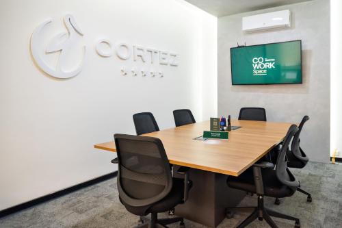 a conference room with a wooden table and chairs at Hotel Cortez in Santa Cruz de la Sierra