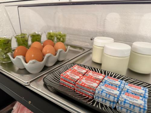 a refrigerator with eggs and other food on a tray at Hôtel Auberge Provençale in Saint-Raphaël