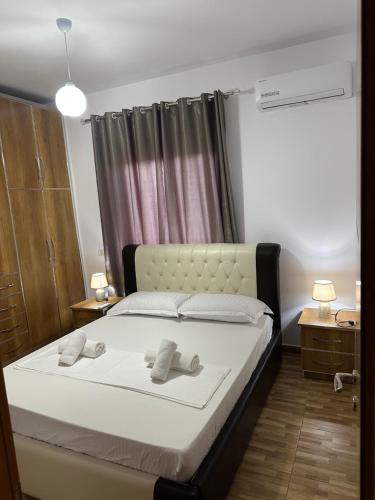 a bedroom with a bed with two towels on it at VILA Moreja in Berat