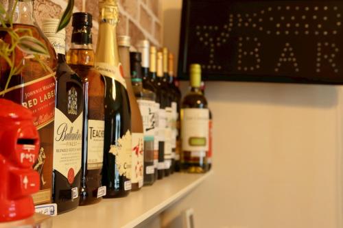 a row of bottles of wine on a shelf at ｄｐ小山町 in Machida